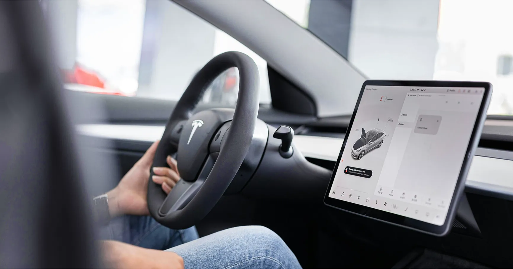 Driver's view of a connected car's dashboard screen with integrated applications.