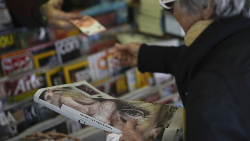 A person buys a copy of a newspaper reporting U.S. President-elect Donald Trump's election win, in Rome, Thursday, Nov. 7, 2024.