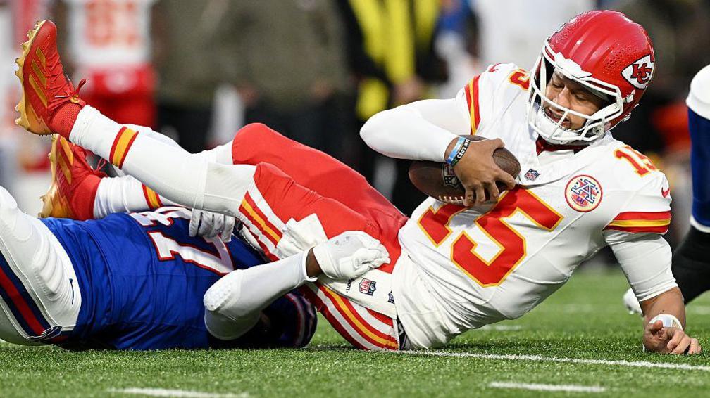 Patrick Mahomes falls on the floor after being hit against the Buffalo Bills in the NFL