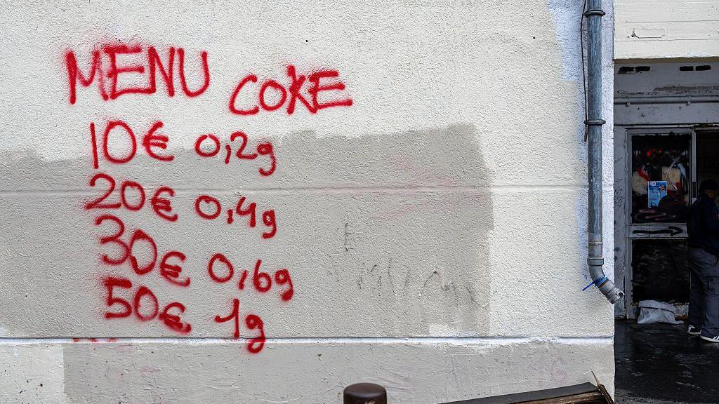 This photograph shows graffiti indicating drug prices on the walls of The Bel Horizon tower, located in the 3rd arrondissement of Marseille, on December 3, 2025