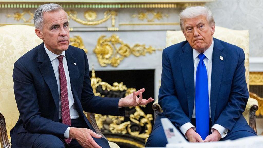 Photo of Canadian Prime Minister Mark Carney next to US President Donald Trump on the right speaking at the White House's Oval Office
