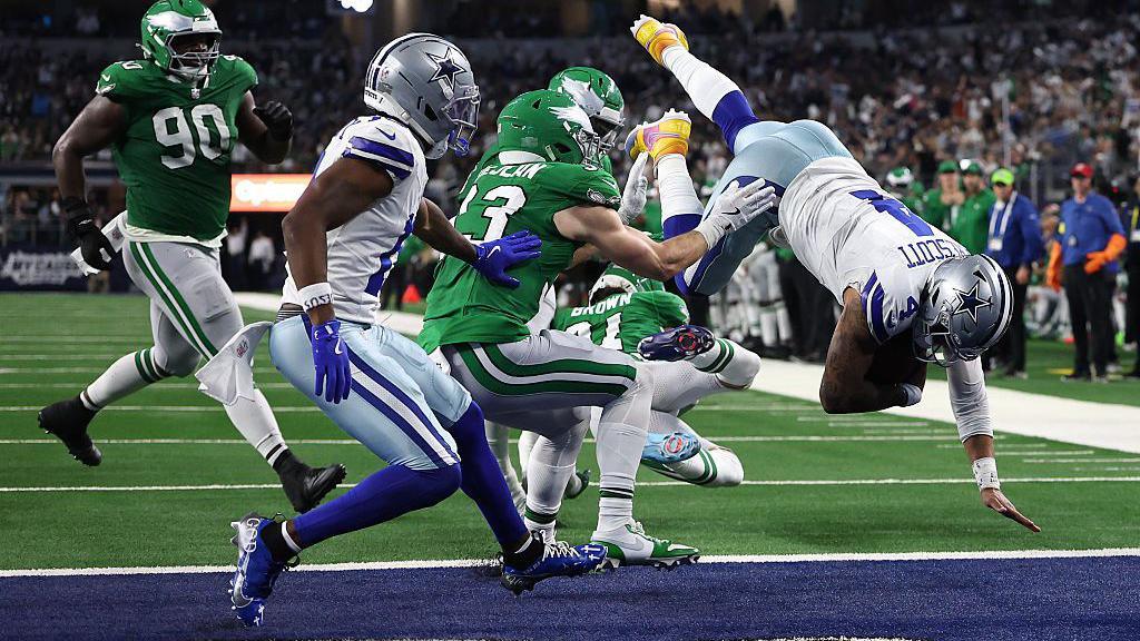 Dak Prescott dives into the end zone to score a touchdown for the Dallas Cowboys