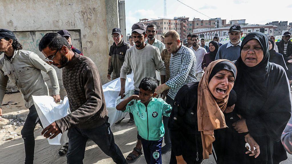 Distressed Palestinian walking down a street