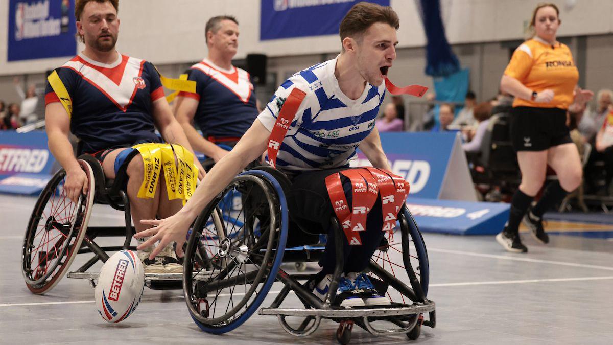 Halifaaz Panthers wheelchair rugby league player Rob Hawkins celebrates as he scores try in the GRand Final against London Roosters.