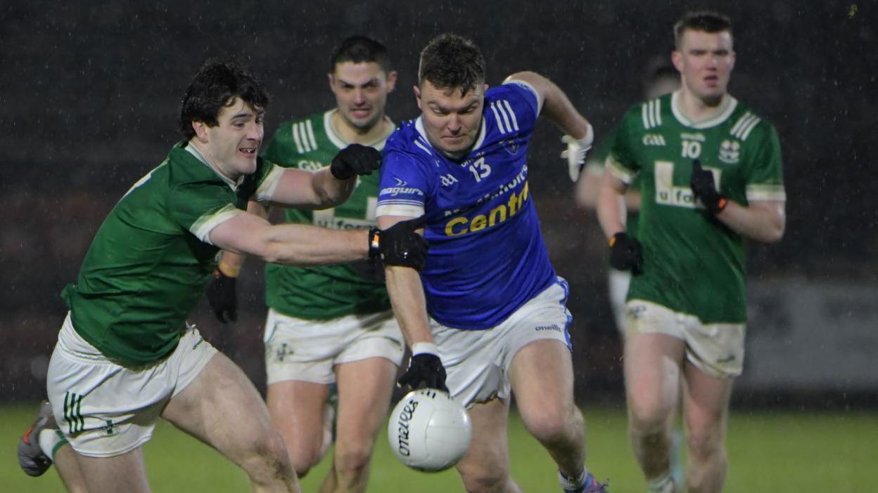 Conor McCarthy is challenged by Padraig McGrogan