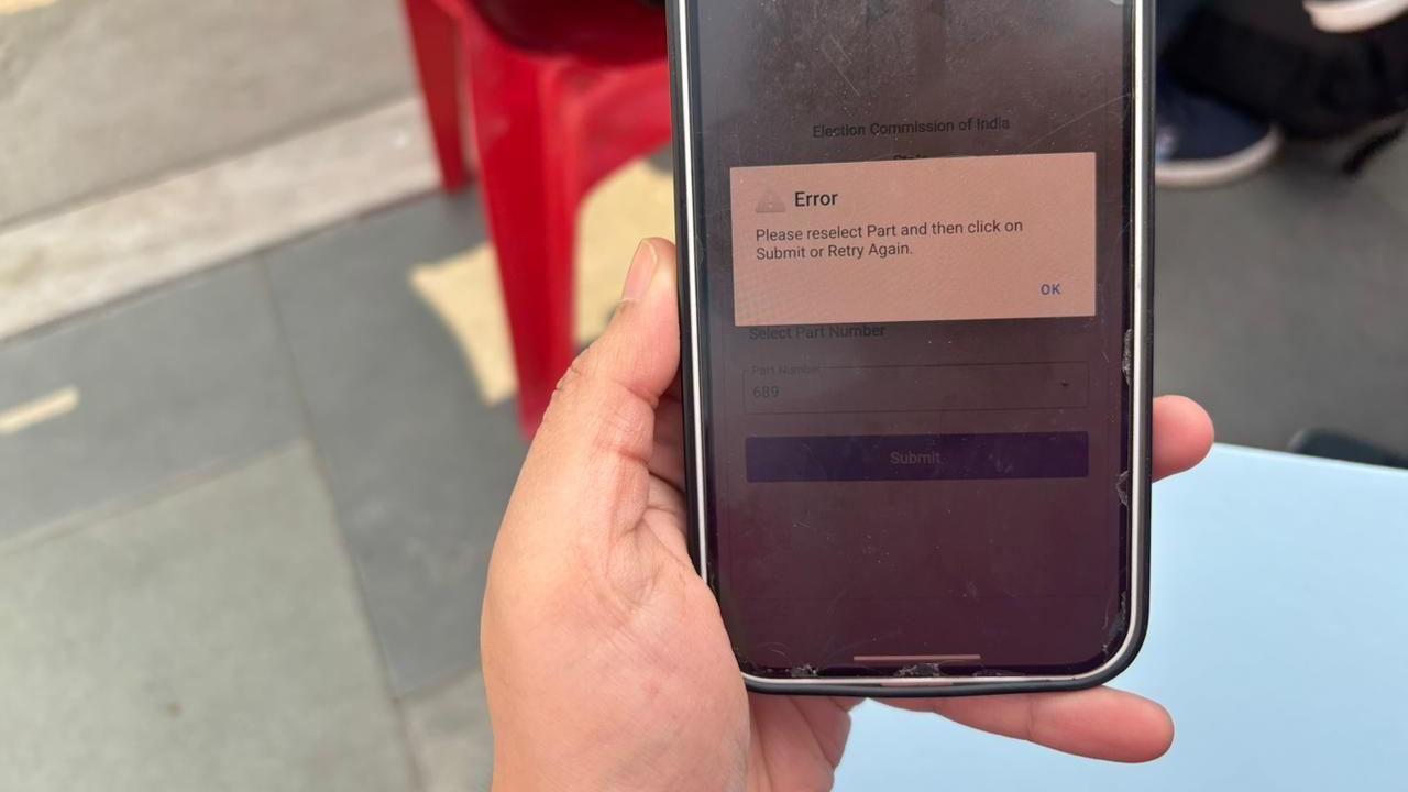 A woman holds a phone with the SIR app open. A message shows that the app has crashed.