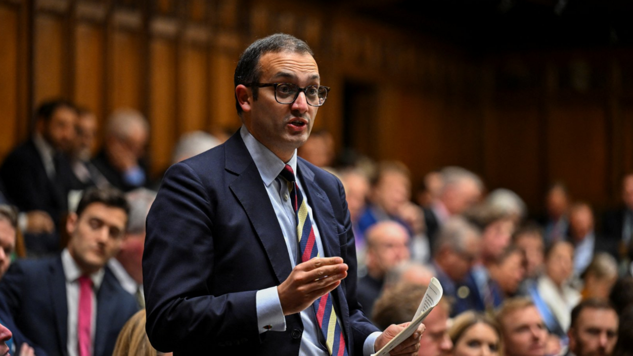 Neil Shastri-Hurst during the Prime Minister's Questions at the House of Commons in London. He is stood in front of other MPs who are seen in the background. He is holding a piece of paper in his left hand and gesturing with his right.