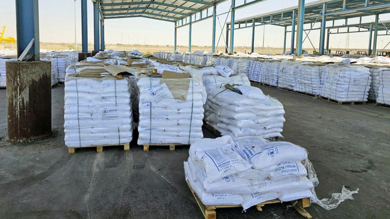 Stacks of aid are seen at the Kerem Shalom crossing between Israel and Gaza