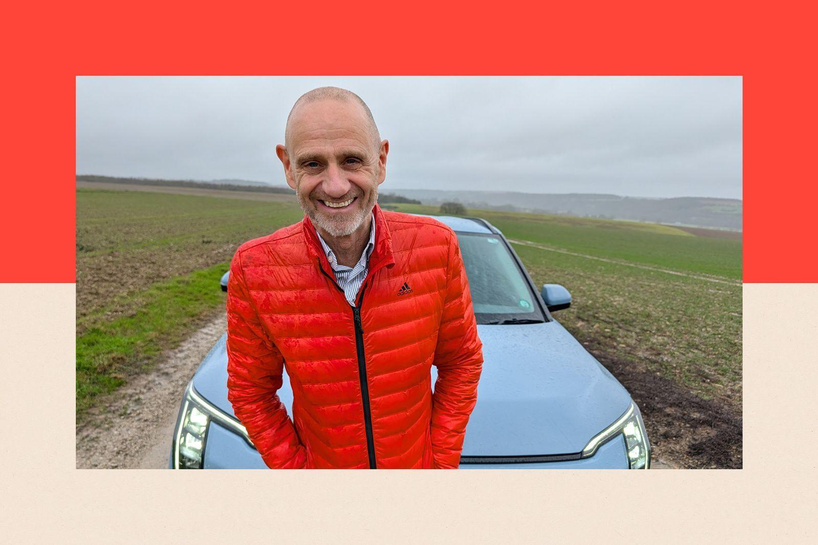 Evan Davis standing in front of a car