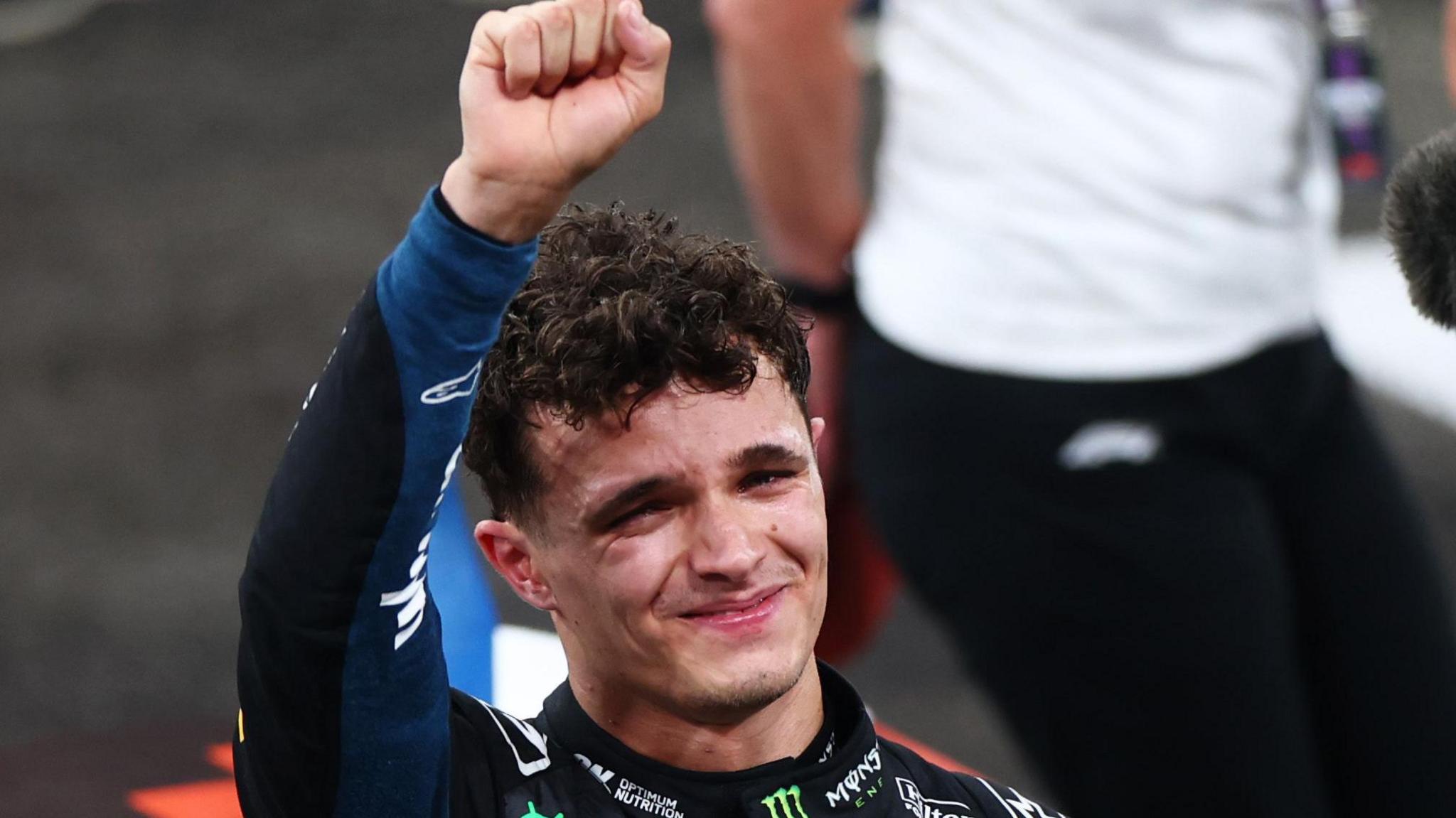 McLaren's Lando Norris is tearful as he lifts his fist in celebration after winning the F1 drivers' title in the Abu Dhabi Grand Prix