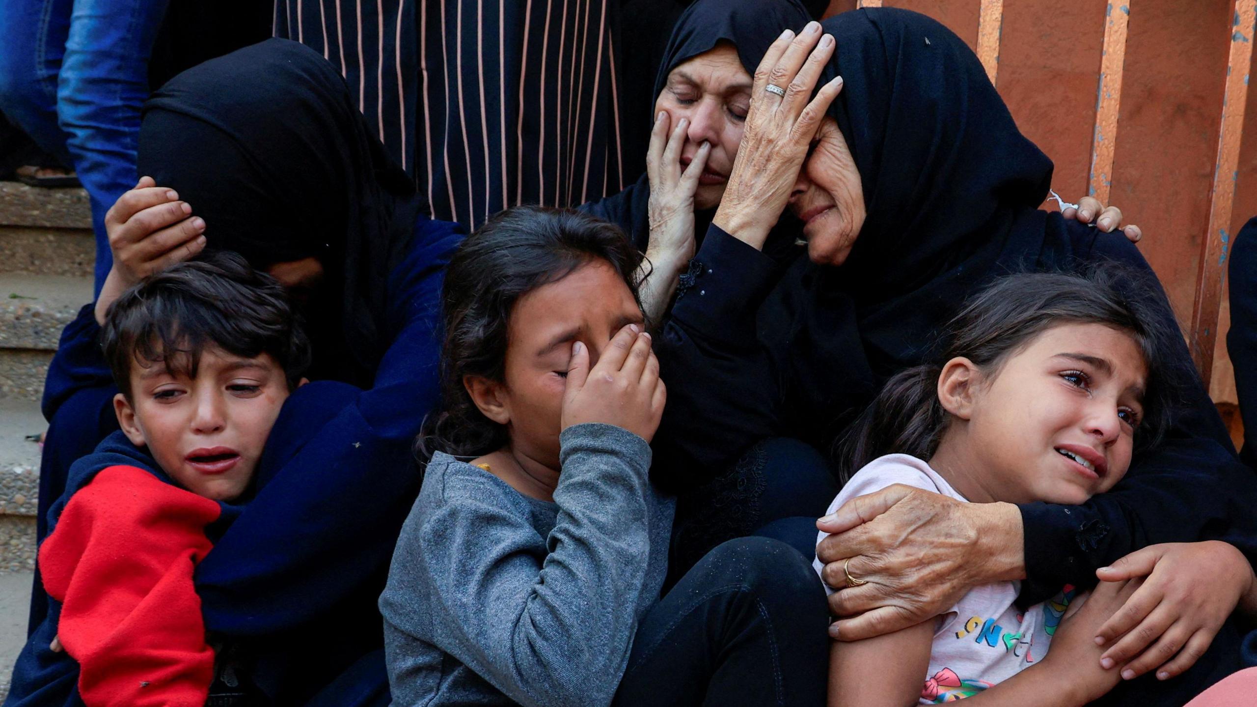 Mourners react during the funeral of Palestinians killed in Israeli strikes, at Nasser hospital, in Khan Younis, southern Gaza Strip, May 21, 2025.