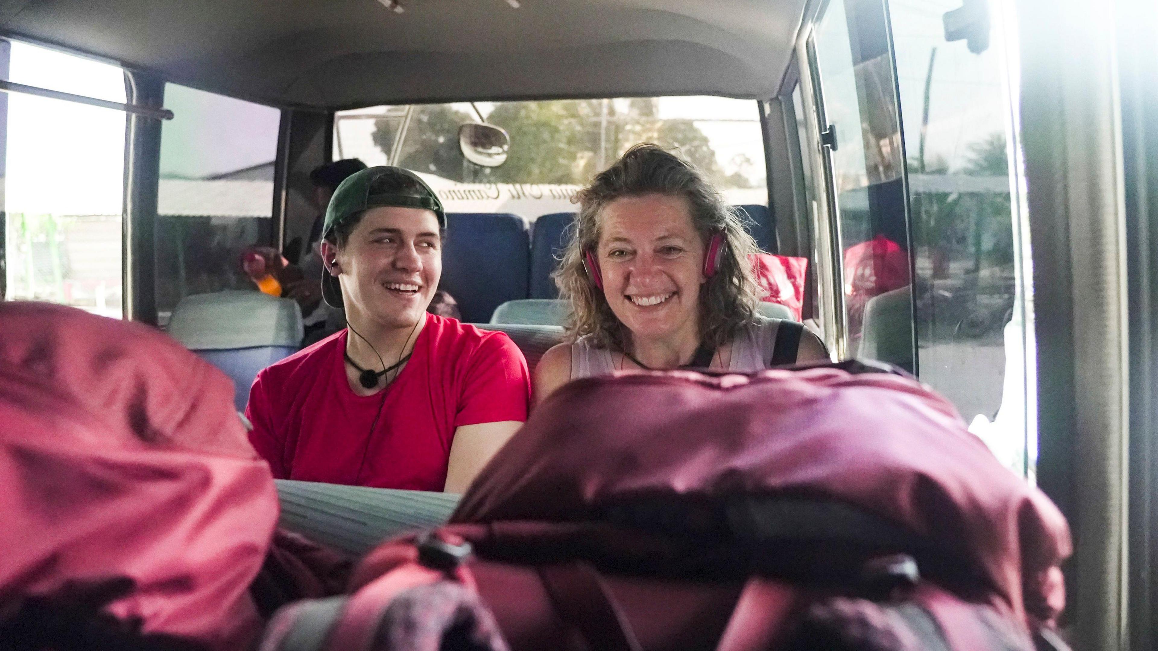 Actor Dylan Llewellyn and mum Jackie sit on a bus whilst travelling.