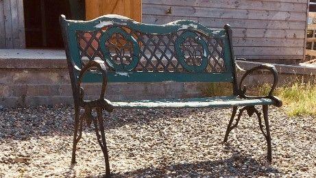 A metal bench in need of repair.