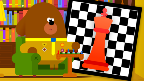 A brown cartoon dog playing chess in an armchair, looking focussed. Behind him, a black and white chequered chess board, a large red king piece.