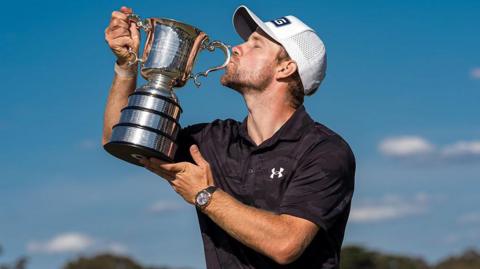 Neergaard-Petersen kisses the Australia Open trophy