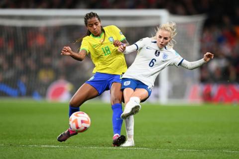 Geyse and Alex Greenwood battle for the ball