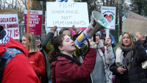 A group of women, one of them with a megaphone, during Saturday's rallies in Inverness.