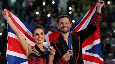Lilah Fear and Lewis Gibson celebrate with their medals