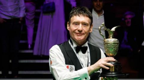 Jimmy White poses with the trophy after winning the final match against Alfie Burden of England on day 5 of the 2023, at the Crucible Theatre in Sheffield.
