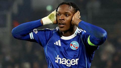 Strasbourg striker Emmanuel Emegha celebrates his goal against Crystal Palace by putting both hands over his ears