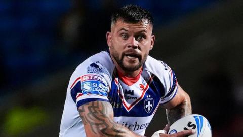 Liam Hood looking up with the ball in his hands