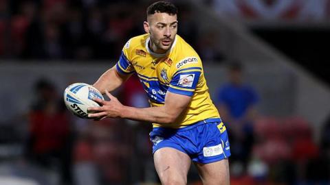 Jake Connor prepares to deliver a pass while in action for Leeds in 2025