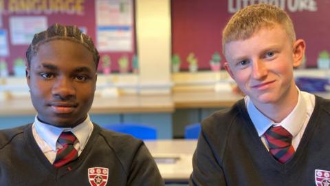 Two teenage boys wearing school uniform