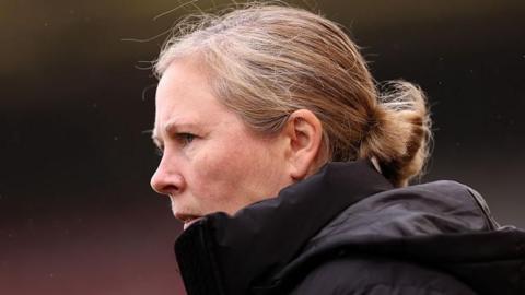 Rehanne Skinner looks on