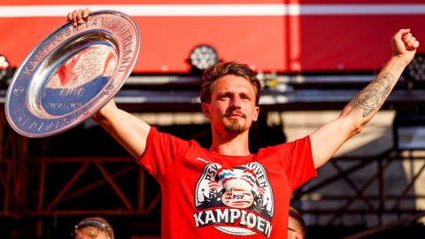 Olivier Boscagli holding a trophy aloft
