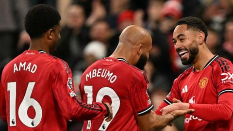 Manchester United players celebrate after a goal