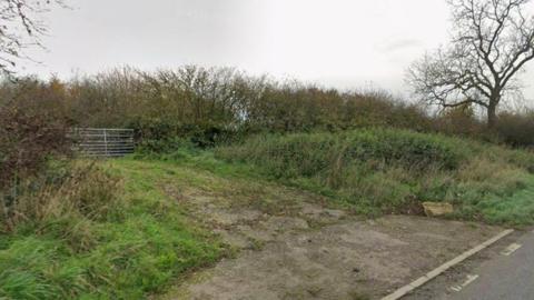 A street view of the gated access to fields off the A47