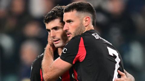 AC Milan's Santiago Gimenez consoles team-mate Christian Pulisic