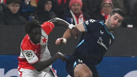 Slavia Prague's Senegalese forward #11 Youssoupha Sanyang (L) and Athletic Bilbao's Spanish defender #12 Jesus Areso Blanco vie for the ball during the UEFA Champions League league phase day 5 football match between Slavia Praha and Athletic Club