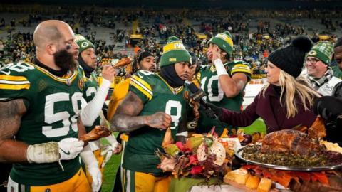 Green Bay Packers players eating turkey after winning on Thanksgiving 2024