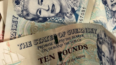 A pile of States of Guernsey ten pound notes.