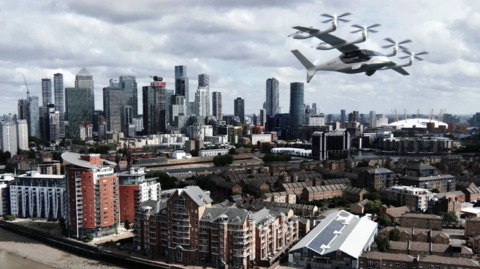 A picture of the London skyline, with the new aircraft flying above. It resembles a small plane with two small propellers along each wing.