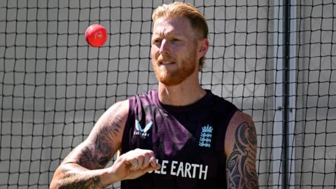 England captain Ben Stokes tosses up a pink ball in training