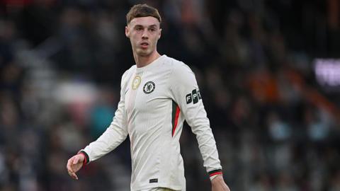 Cole Palmer stood on the pitch looking at the ball against Bournemouth