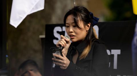 Carmen Lau, activist in exile and former Pro-democratic District Councilor of Hong Kong, seen making speeches during the rally outside Downing Street in 2022.