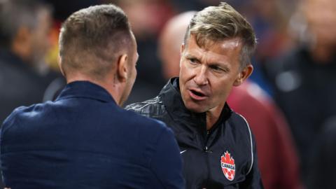 Craig Bellamy (left) in discussion on the touchline with Jesse Marsch