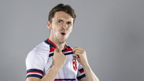 Rob Hawkins looks at the camera and celebrates