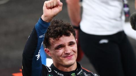 McLaren's Lando Norris is tearful as he lifts his fist in celebration after winning the F1 drivers' title in the Abu Dhabi Grand Prix