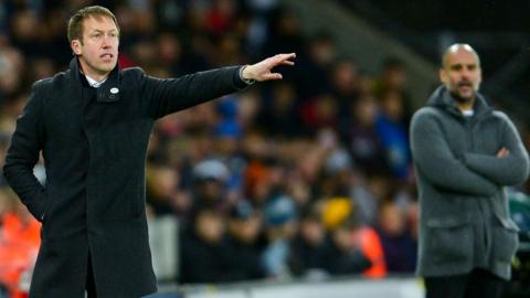 Swansea City boss Graham Potter points while Manchester City's Pep Guardiola looks on with arms folded