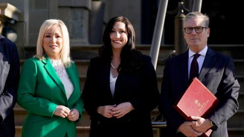 First Minister Michelle O'Neill, Deputy First Minister Emma Little-Pengelly and Prime Minister Sir Keir Starmer at Stormont Castle last year