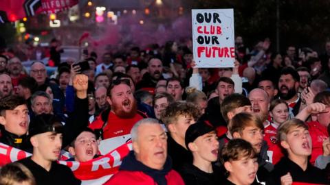 Salford Red Devils fans protest before their game against St Helens towards the end of the 2025 season
