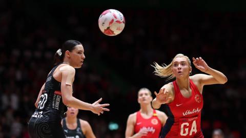 Helen Housby and Karin Burger go for the ball during England's match against New Zealand in Manchester