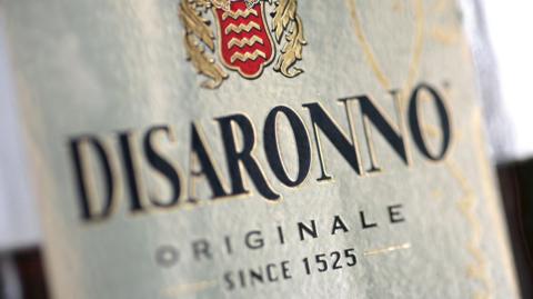 The distinctive gold label of Disaronno Originale - Since 1525 - it is a very close up shot of the bottle with nothing visible around it