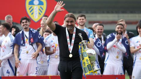 Players from Championship winners Leeds celebrate with manager Daniel Farke