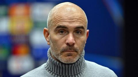 Enzo Maresca looking straight into the camera with a glum expression