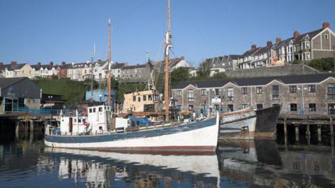 Boats and houses Milford Haven harbor, Pembrokeshire, Wales.